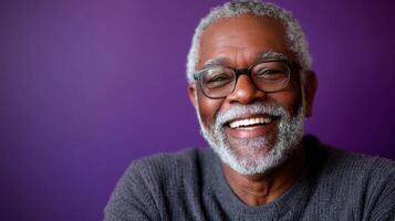 An older man with glasses and a beard smiling photo