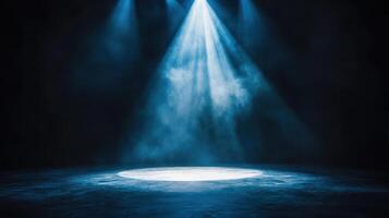A spotlight shines on a stage with smoke photo