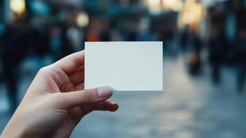 A person holding up a blank piece of paper photo