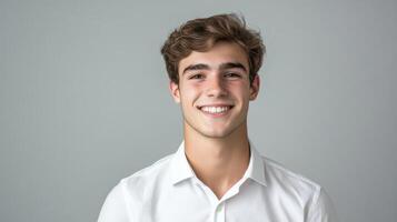 Portrait of a smiling young man on gray background photo