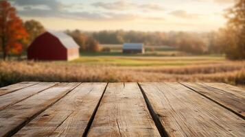Wooden table top over a field with a barn in the background photo