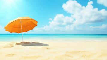 An orange umbrella on the beach with the ocean in the background photo