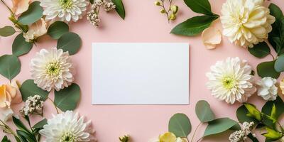 Flowers and leaves on pink background with blank card photo
