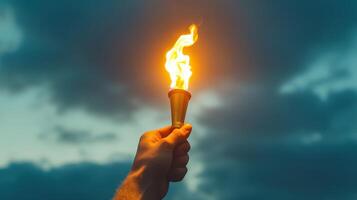 A person holding a torch with a flame in their hand photo