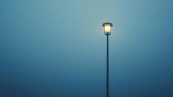 A street light is lit up in the dark photo
