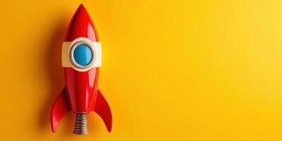 A red rocket ship on a yellow background photo