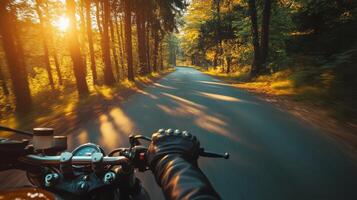 A person riding a motorcycle on a road in the woods photo