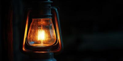 An old fashioned light bulb is lit up in the dark photo