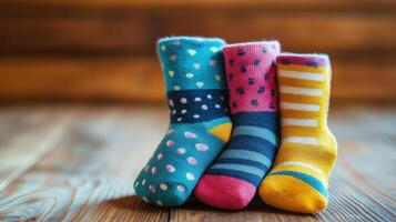 Three pairs of colorful socks on a wooden table photo