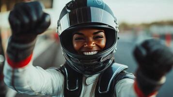 A woman in a helmet and racing suit is smiling photo