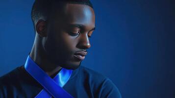 A man with blue tie looking down photo
