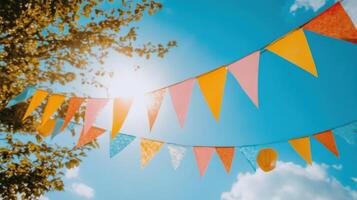 Colorful bunting hanging from a tree photo