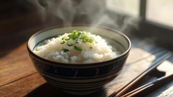 A bowl of rice with chopsticks on a table photo