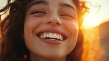 A woman with curly hair smiling at the sun photo