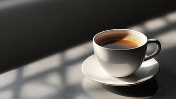 A cup of coffee on a table with sunlight photo