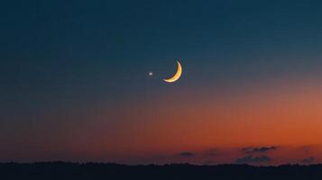 The moon and a crescent are seen in the sky photo
