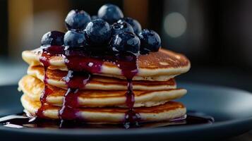 A stack of pancakes with blueberries on top photo