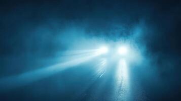A car driving through a foggy road at night photo
