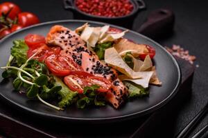 Delicious fresh caesar salad with salmon, lettuce, tomatoes and egg photo