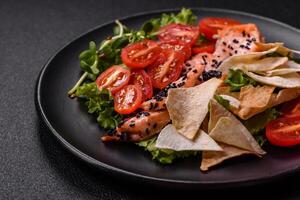 Delicious fresh caesar salad with salmon, lettuce, tomatoes and egg photo