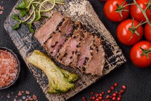 Bowl with slices of baked tuna with broccoli, tomatoes and fusili pasta photo