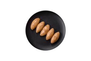 Fish or meat quenelles with delicate mushroom sauce, salt and spices photo