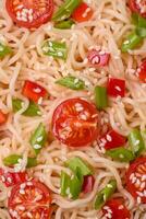 Rice noodles with mushrooms, vegetables, spices and herbs photo