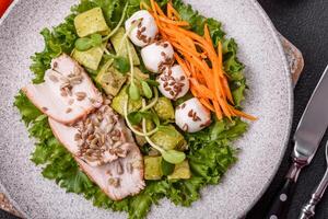 Delicious diet salad with turkey or chicken slices, lettuce, carrots, mozzarella photo