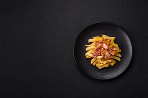 Crispy French fries with pieces of bacon, salt and spices photo