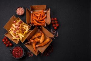 Crispy French fries with pieces of bacon, salt and spices photo