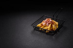 Crispy French fries with pieces of bacon, salt and spices photo