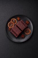 Rectangular chocolate candies with mousse and waffles photo