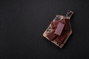 Rectangular chocolate candies with mousse and waffles photo