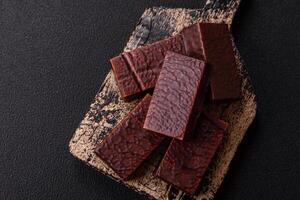 Rectangular chocolate candies with mousse and waffles photo