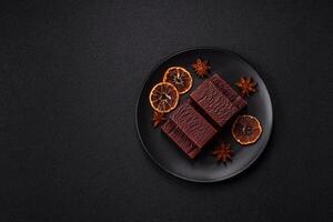 Rectangular chocolate candies with mousse and waffles photo
