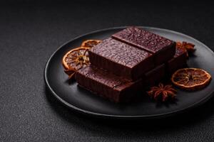 Rectangular chocolate candies with mousse and waffles photo