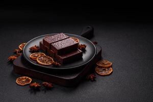 Rectangular chocolate candies with mousse and waffles photo