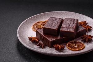 Rectangular chocolate candies with mousse and waffles photo