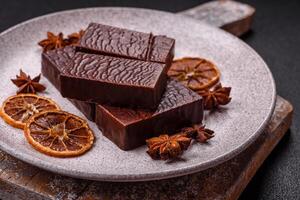 Rectangular chocolate candies with mousse and waffles photo