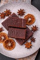 Rectangular chocolate candies with mousse and waffles photo