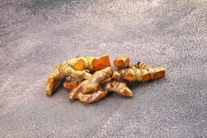 Fresh young Tumeric root heap photo