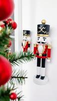 Nutcracker Ornament on White Background with Christmas Tree Branch photo