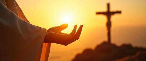 Hand reaching towards the sun with cross in the background photo