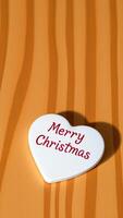 White Heart With Red Merry Christmas Text On Wooden Background photo