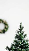 Minimal Christmas Tree with Blurred Wreath in Background photo