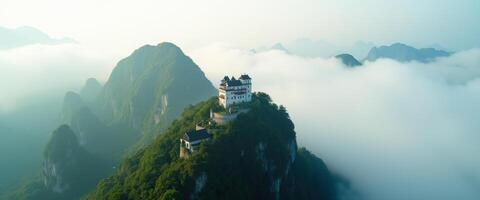 Castle on a Mountain Peak in a Sea of Clouds photo