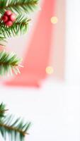 Christmas Tree Branch With Red Ornament And Bokeh Lights photo