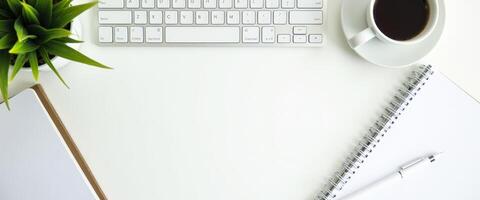 Minimalist Workspace with Coffee, Keyboard, and Notebook photo