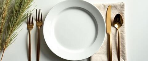Elegant Table Setting with Gold Flatware and White Plate photo