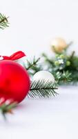 Red and White Christmas Baubles with Pine Branches on White Background photo
